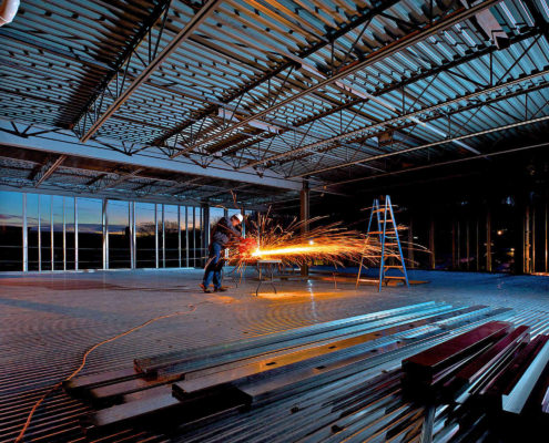Construction worker cutting metal